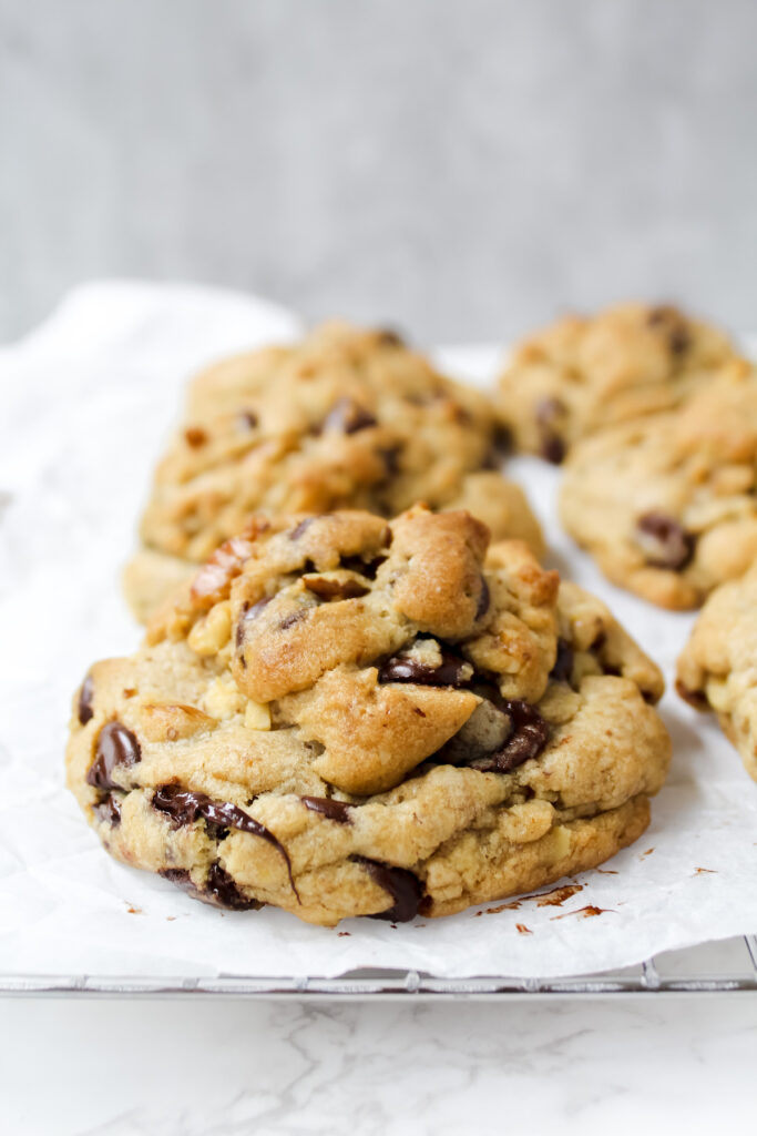 side angle shot of a row of vegan copycat Levain Bakery chocolate chip cookies