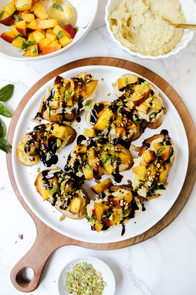 picture of peach bruschetta on a plate on a wooden board