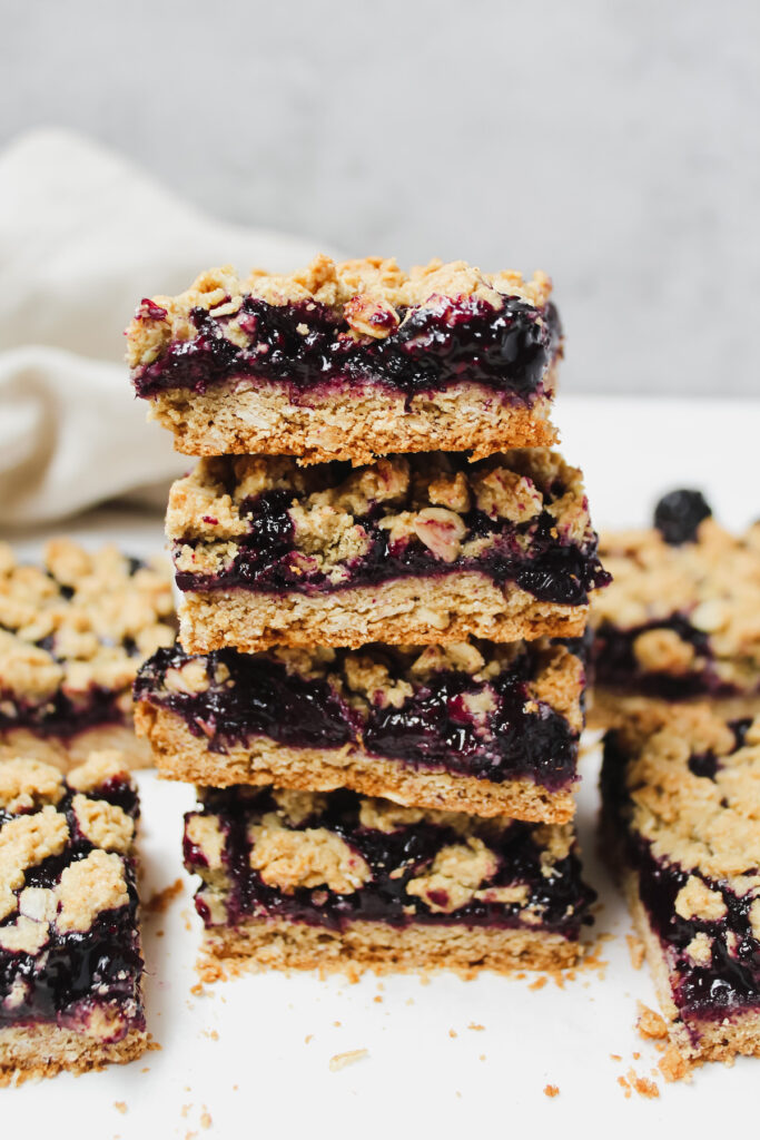 four crumble bars stacked on top of each other 