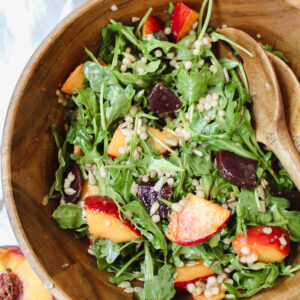 close up shot of couscous salad in a wooden bowl