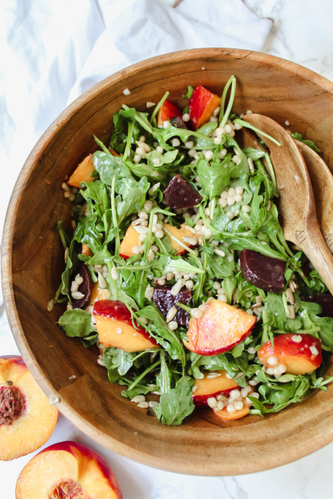 close up shot of couscous salad in a wooden bowl