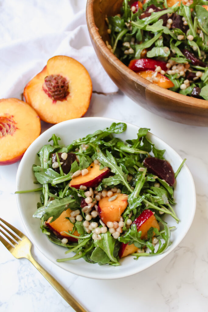 peach beet couscous salad in a white bowl