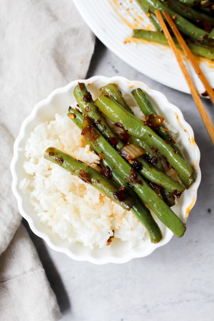 bowl of rice with string beans on top