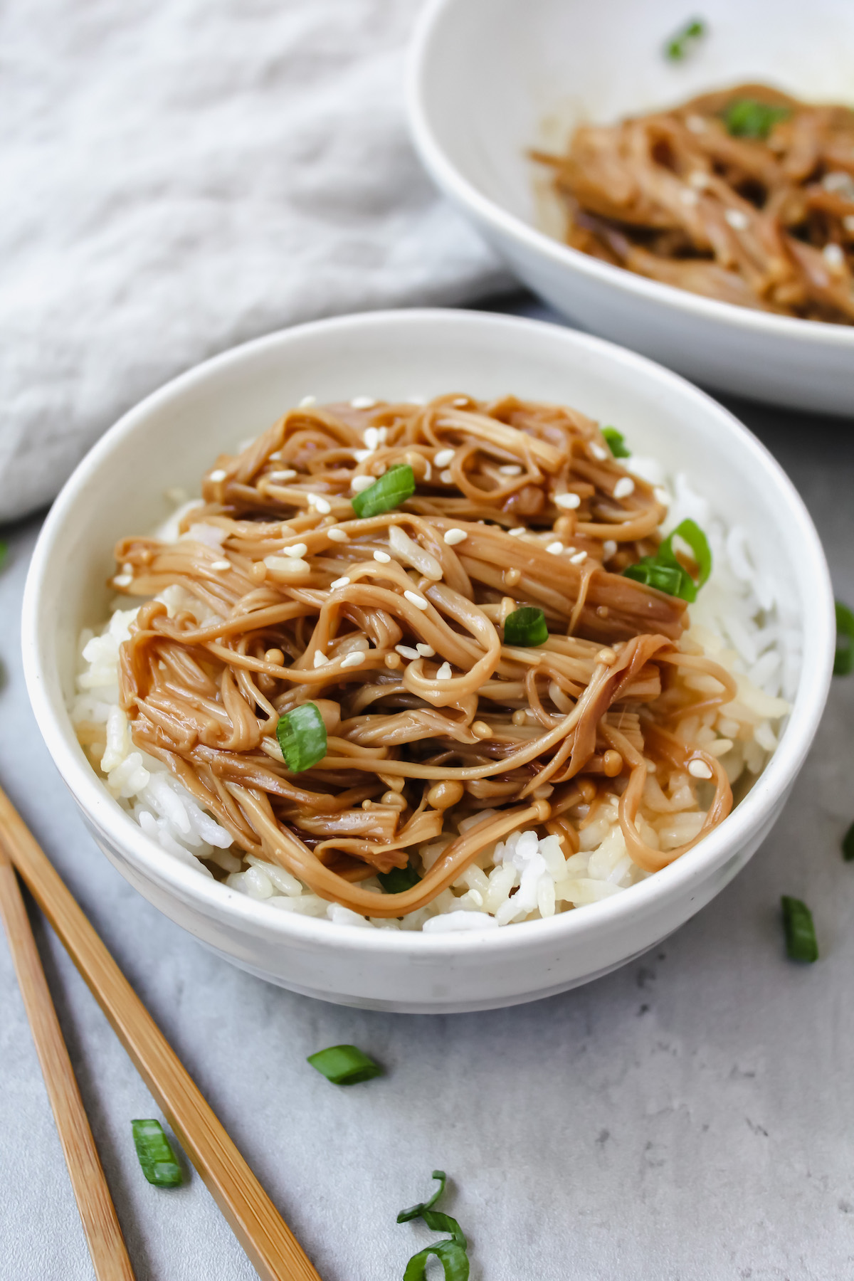 angled shot of bowl of rice with mushrooms on top