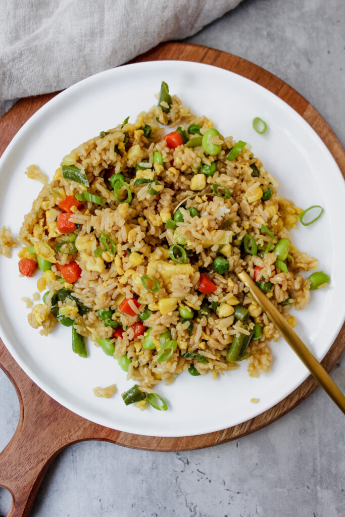 vegan egg fried rice on a plate with a spoon in it