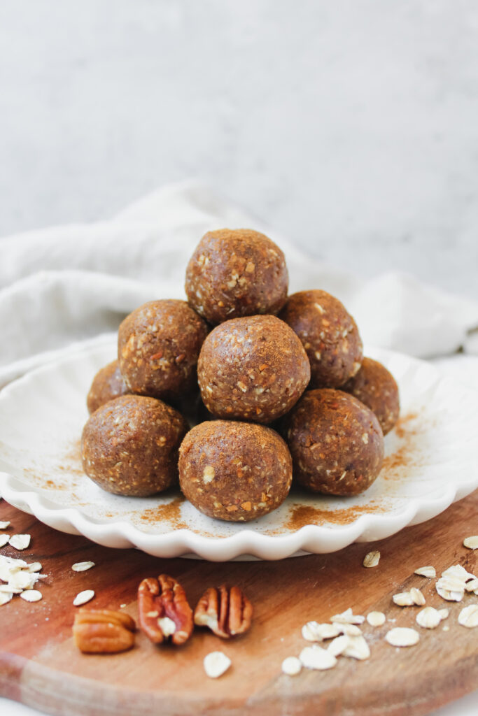 side view of stack of apple pie energy bites on a plate