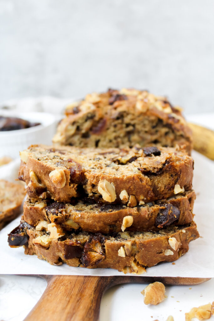 three slices of banana date nut bread stacked on top of each other