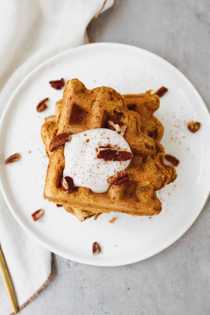 overview shot of pumpkin waffles with yogurt and pecans