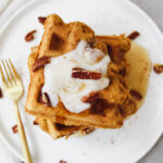 overview shot of pumpkin waffles with maple syrup