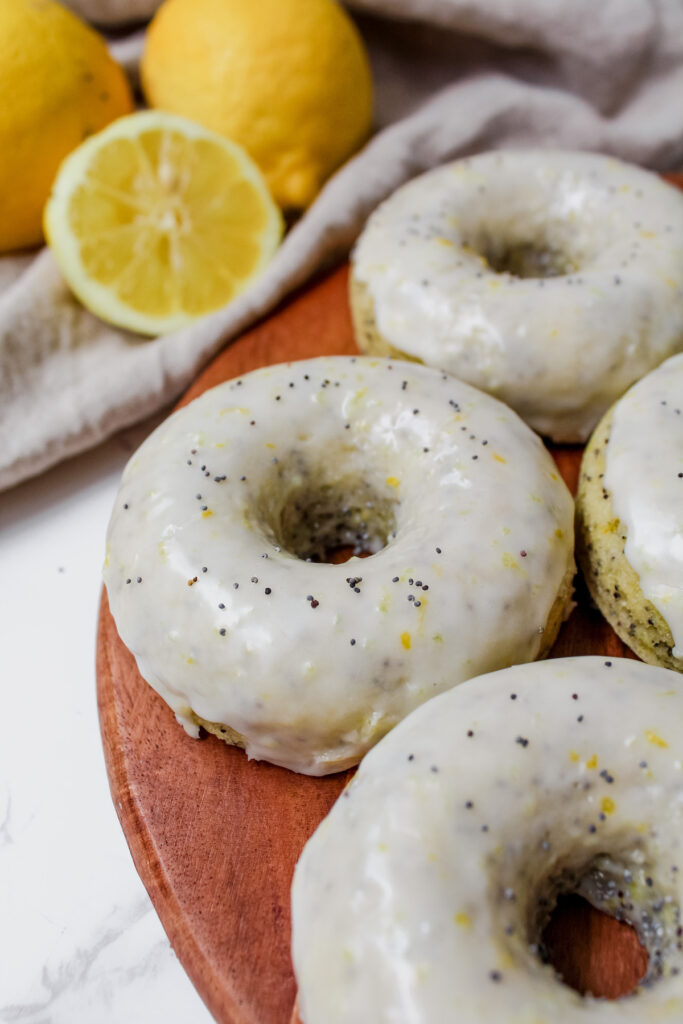 angled shot of lemon poppy seed donut on a board