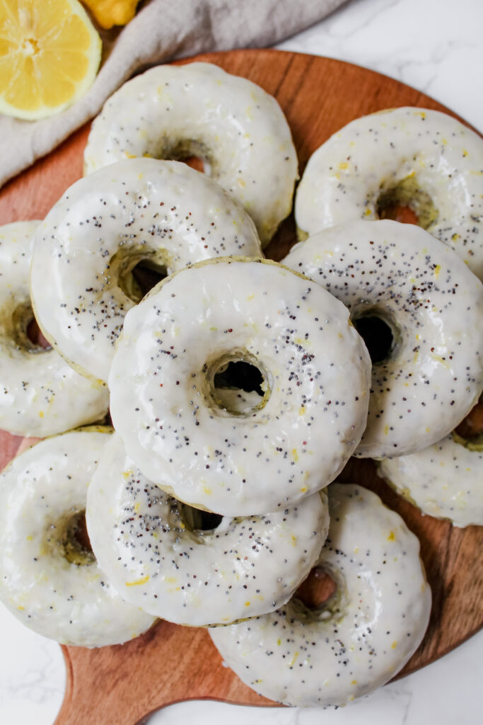 overview shot of stacked donuts on a wooden board