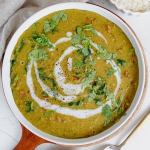 overview shot of bowl of easy red lentil dal with naan on the side