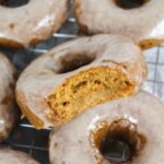 bite taken out of a pumpkin donut