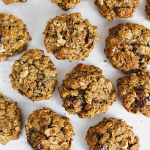 overview shot of a bunch of oatmeal date walnut cookies on a pan