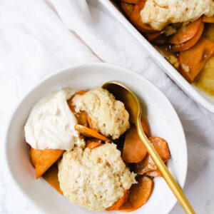 overview shot of a bowl of persimmon cobbler and the pan