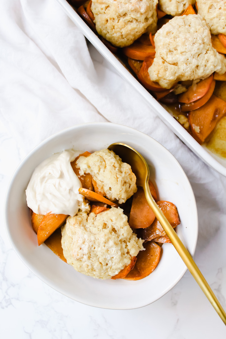 overview shot of a bowl of persimmon cobbler and the pan