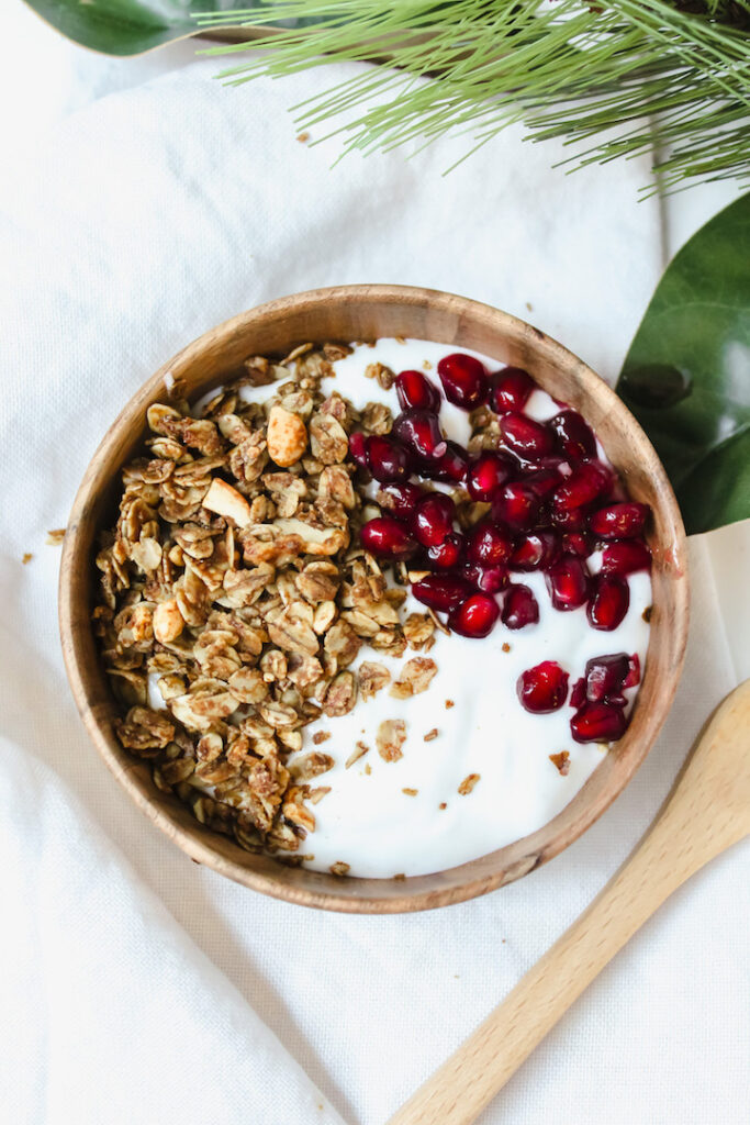 yogurt bowl with gingerbread granola and pomegranate seeds 