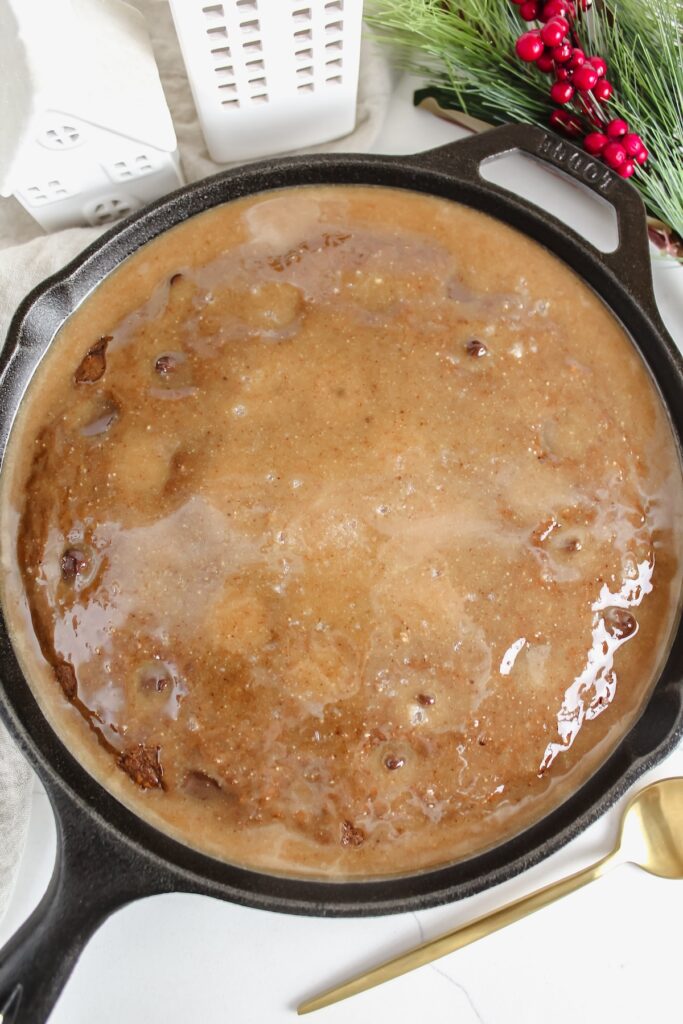 overview shot of chocolate chip gingerbread skillet cake with salted caramel sauce on top