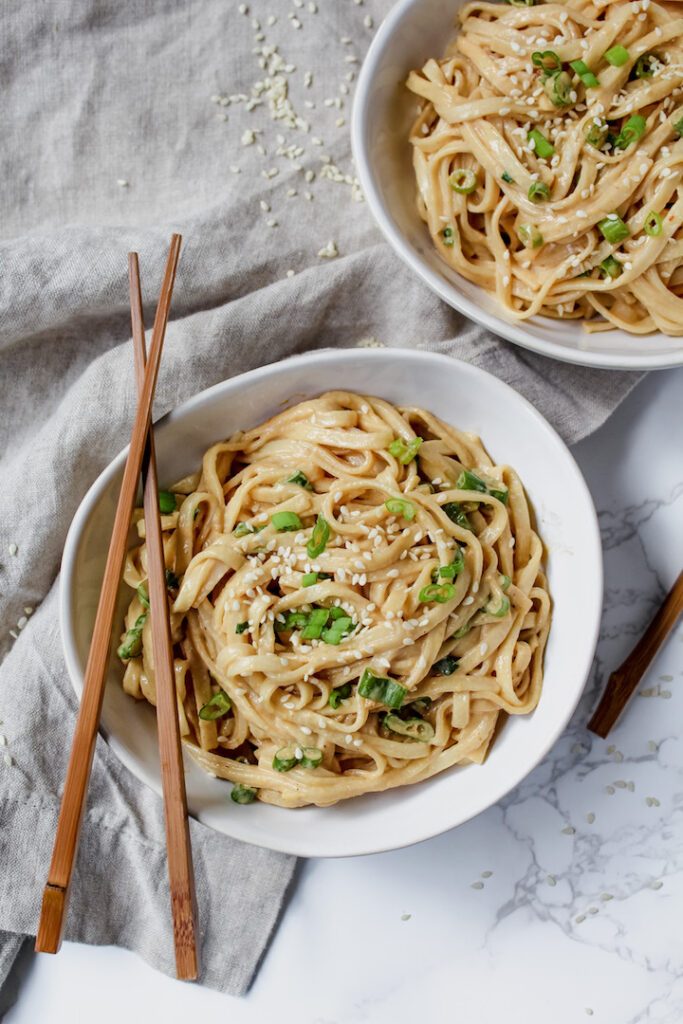 overview shot of noodles with chopsticks on top of bowl