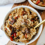 close up shot of a bowl of vegan rice cooker chinese sticky rice with a spoon in it