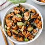 overview shot of a bowl of thai basil tempeh and brussels sprouts stir fry with chopsticks on the side