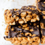 two peanut butter chocolate protein cheerio bars stacked on top