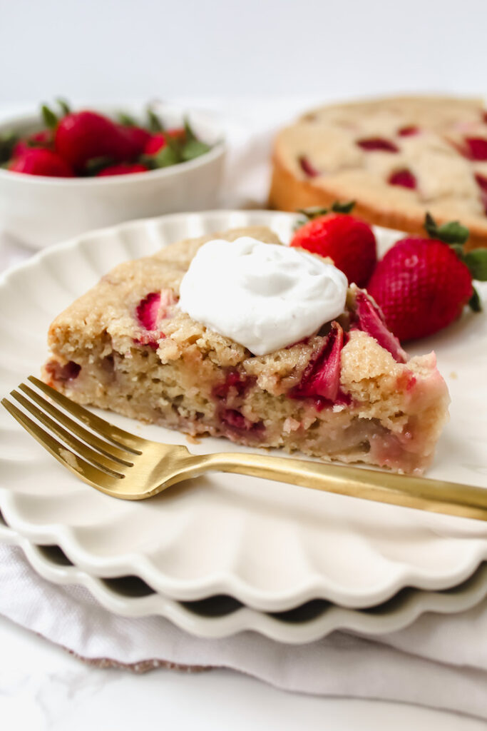 Slice of strawberry cake on two plates stacked