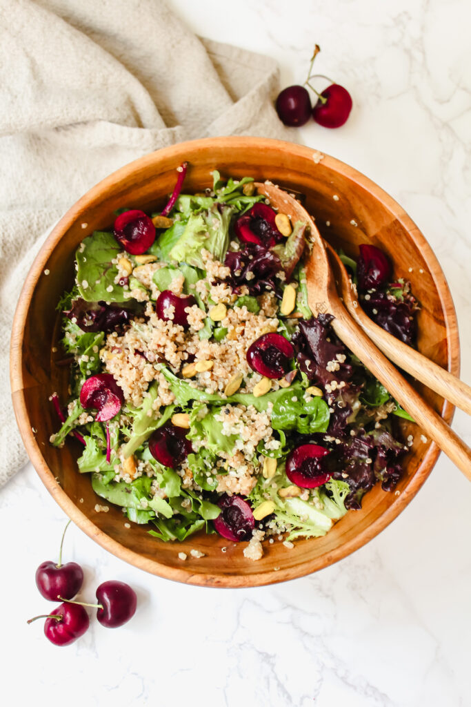 overview shot of simple cherry quinoa salad with balsamic dressing in a wooden bowl