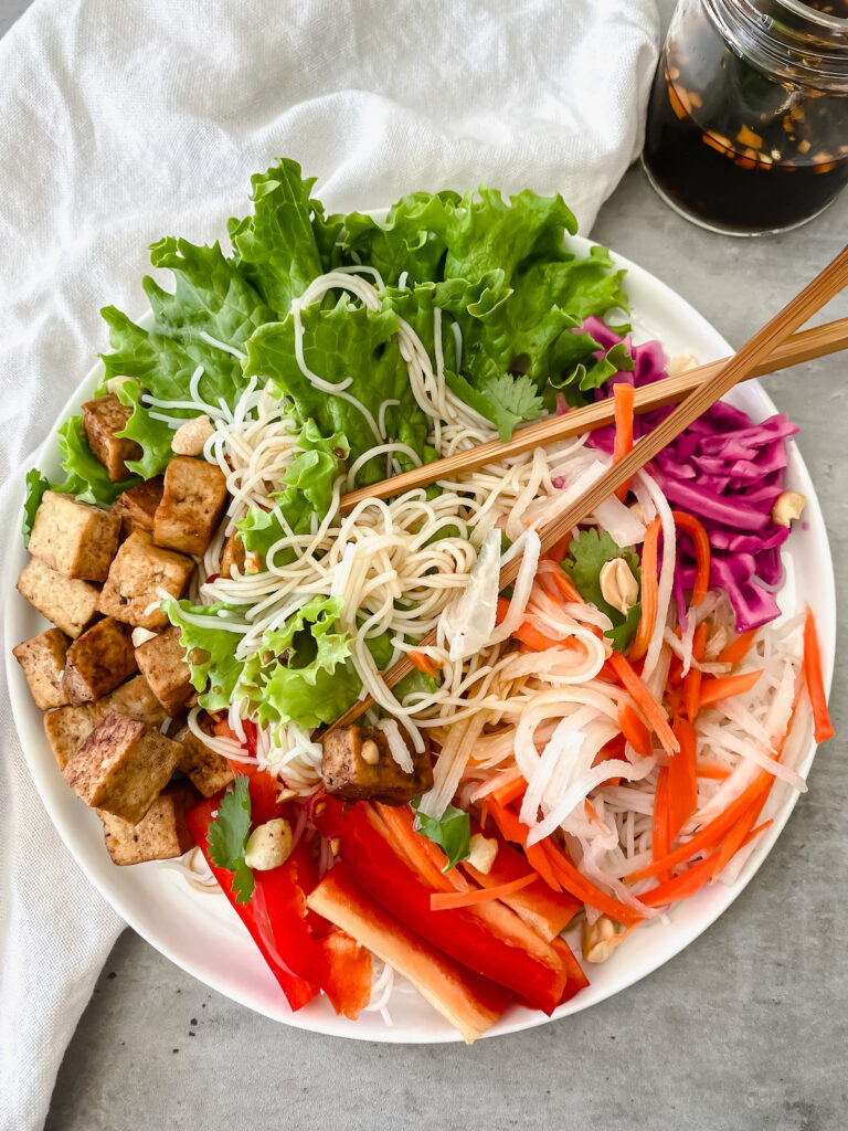 vermicelli tofu bowl all mixed up with chopsticks