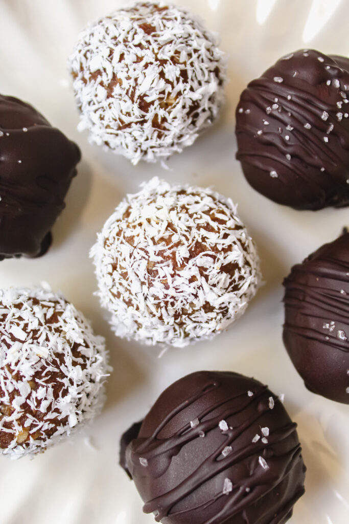 close up overview of a coconut covered pumpkin pie truffle