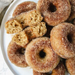 plate of donuts with one donut broken in half