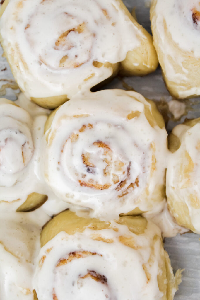 close up of vegan cinnamon rolls with cream cheese frosting