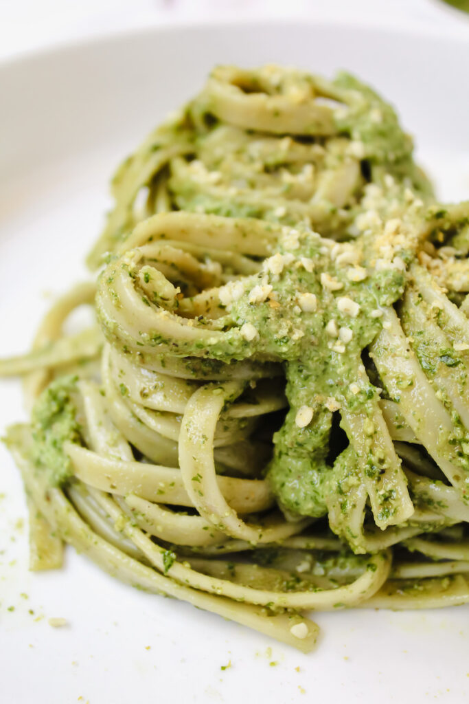 side view shot of twirled pasta with pesto