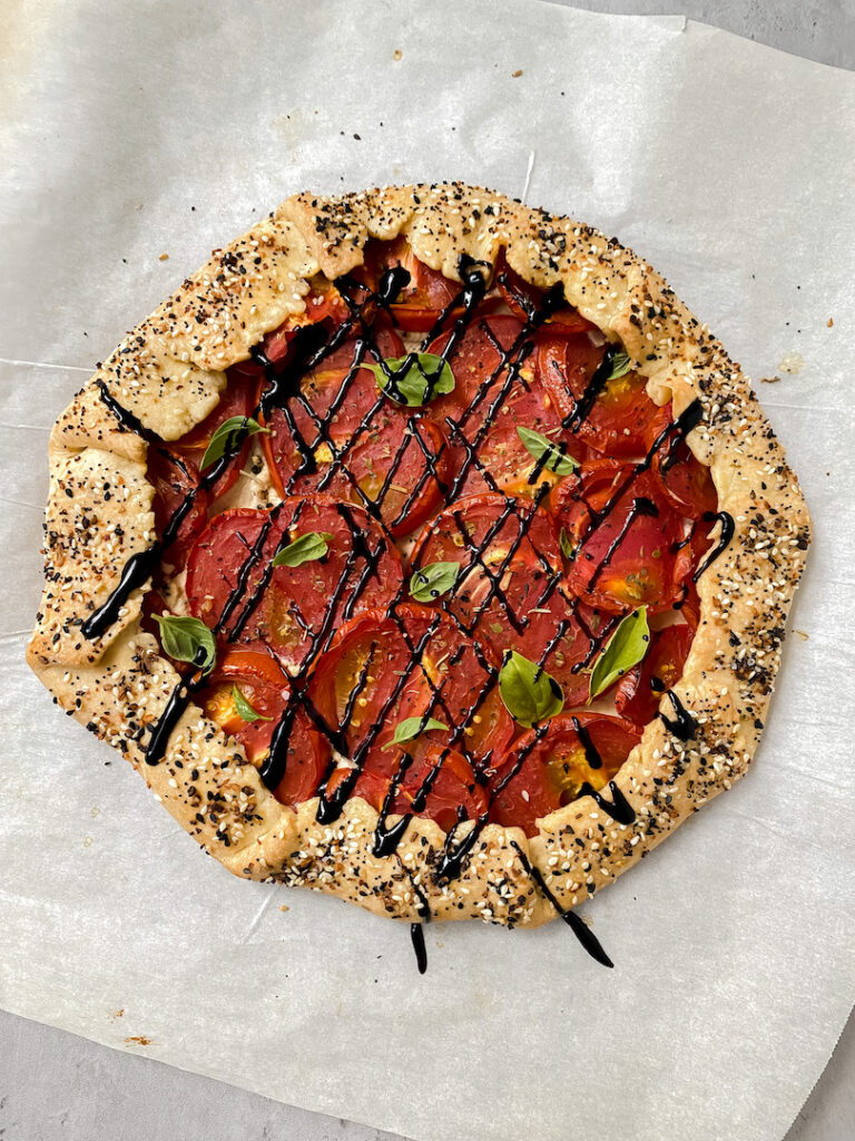 picture of entire tomato galette with balsamic glaze drizzled on top