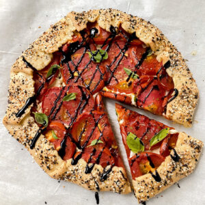 overview shot of tomato galette with a slice cut out