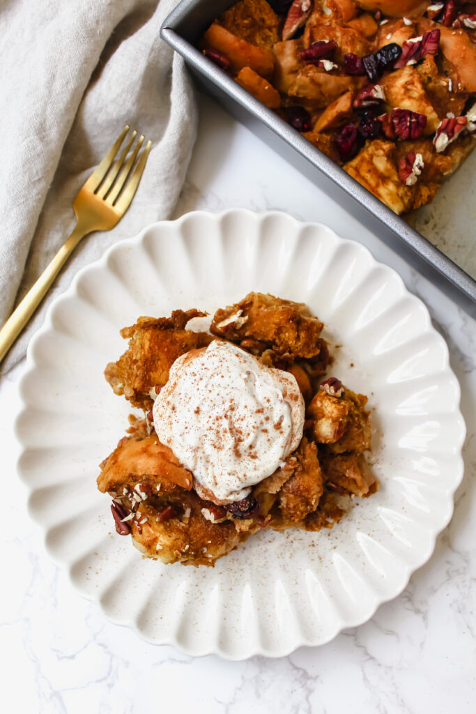 pumpkin french toast casserole on a plate with yogurt and cinnamon on top