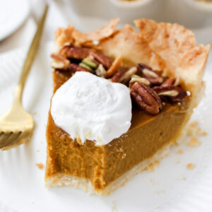 a bite out of a slice of pumpkin pie