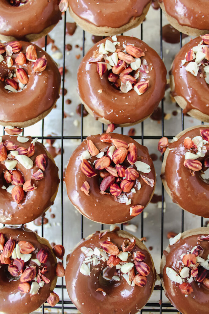 overview shot of peanut butter donuts all lined up on the wire rack