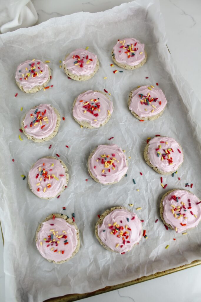 sheet pan with frosted sugar cookies on it