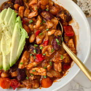 overview shot of easy tempeh chili with spoon in the bowl