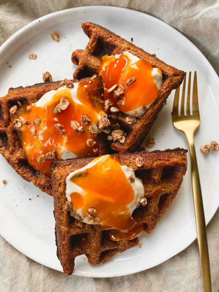 blender persimmon oat waffles with yogurt, persimmons, and granola on top