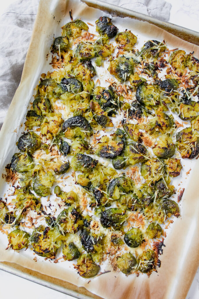 overview shot of pan of vegan parmesan smashed brussels sprouts
