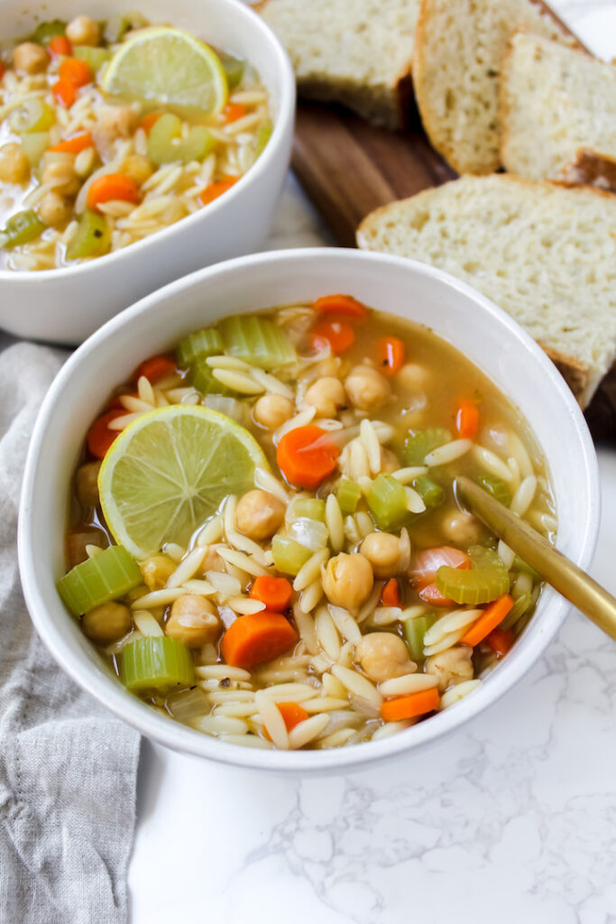 angled shot of a bowl of orzo soup