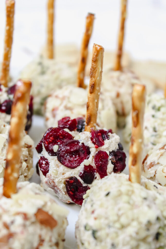 close up of vegan cheese ball bite coated in dried cranberries