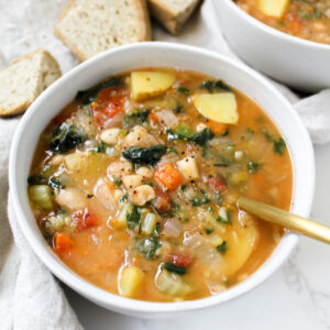 angled shot of a bowl of tuscan white bean and kale soup