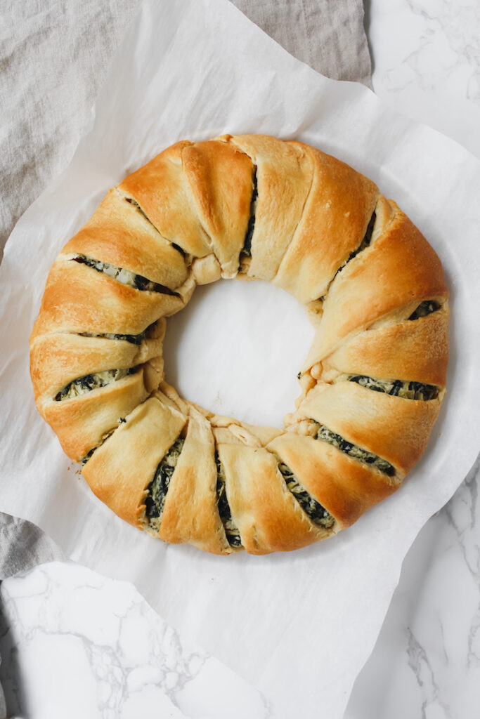 overview shot of vegan spinach artichoke crescent ring baked to a golden color