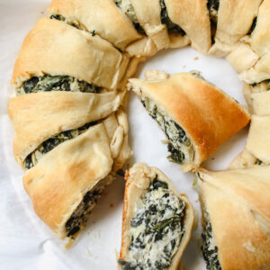 photo of half the vegan spinach artichoke crescent ring with two slices cut out