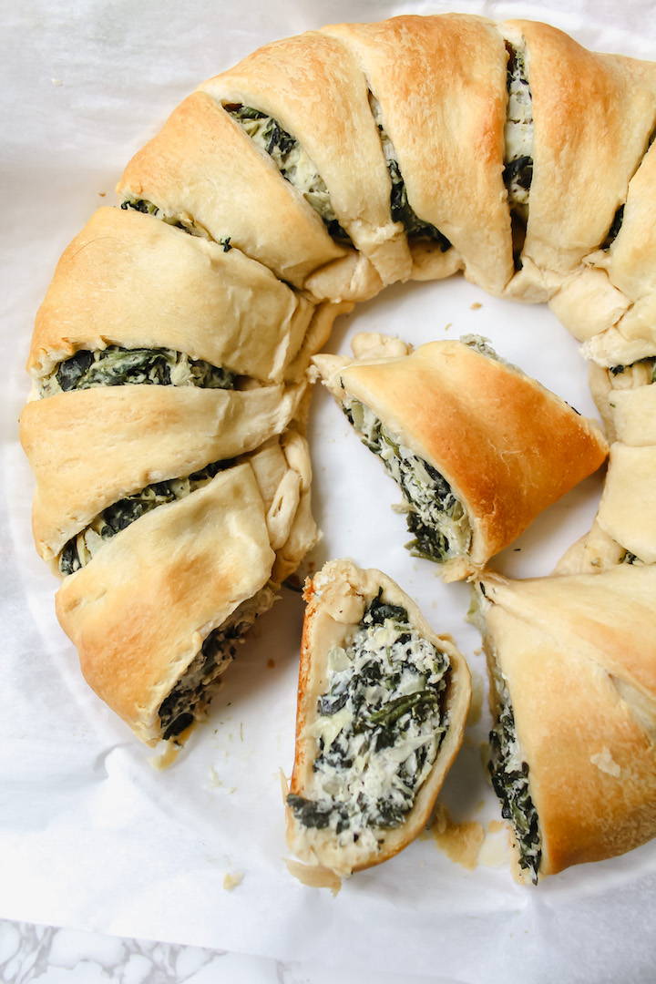 photo of half the vegan spinach artichoke crescent ring with two slices cut out