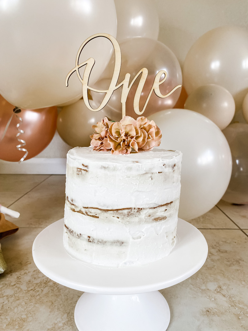 picture of the healthy baby smash cake with flowers and a number one cake topper
