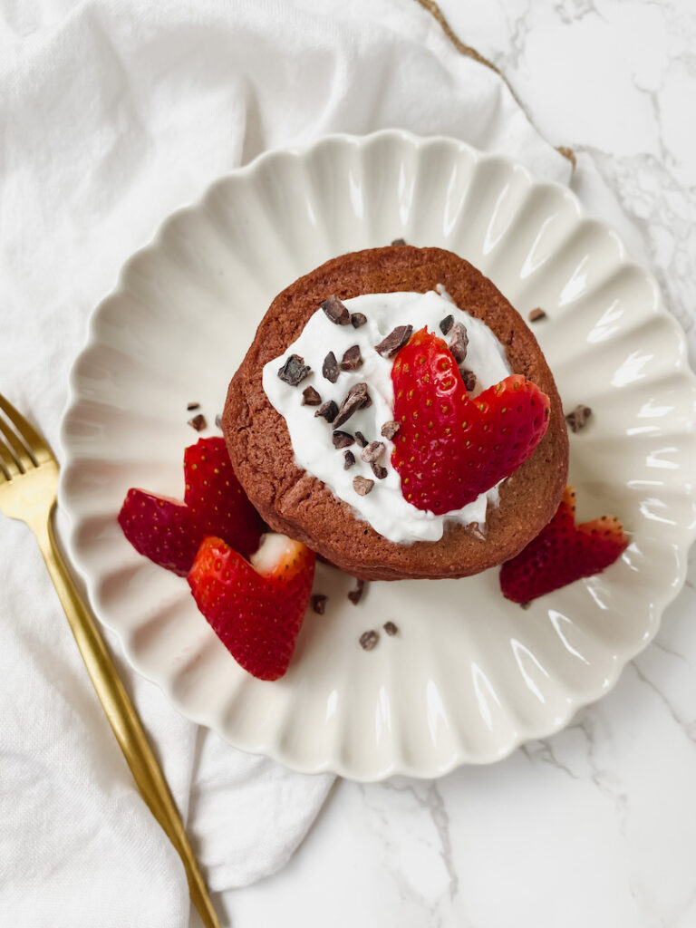 overview picture of red velvet pancakes with heart shaped strawberries